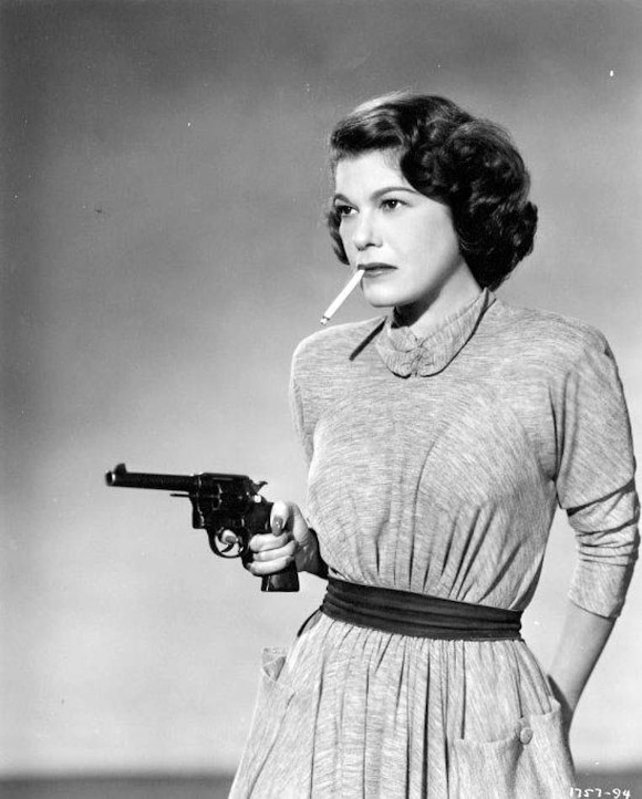 Photo of Betty Lou Gerson carrying a gun with a cigarette dangling from her mouth from the 1950 movie The Red Menace