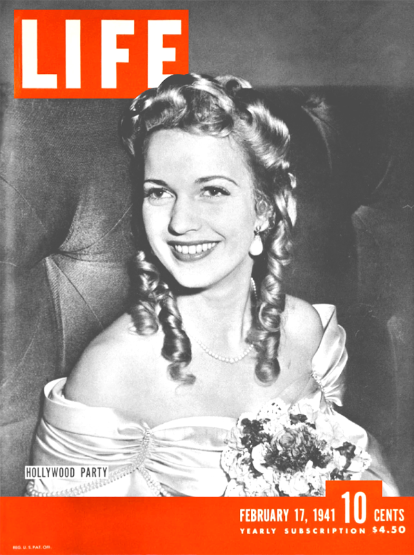 A photo of Cobina Wright Jr. on the cover of the February 17, 1941, issue of Life Magazine. She's seated and wearing a formal dress with bare shoulders and a large flower on the front. Her hair is curled and she's smiling. A caption reads 'Hollywood Party.'
