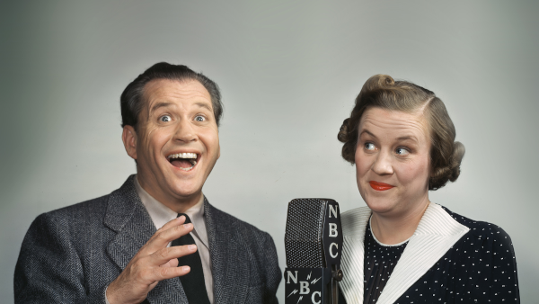 Photo of Jim and Marian Jordan performing Fibber McGee and Molly on an NBC radio microphone