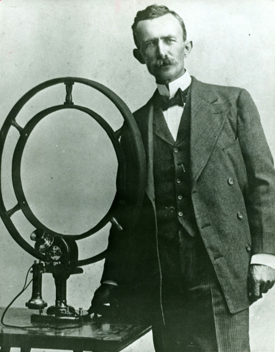 Nathan B. Stubblefield standing beside his invention in 1908