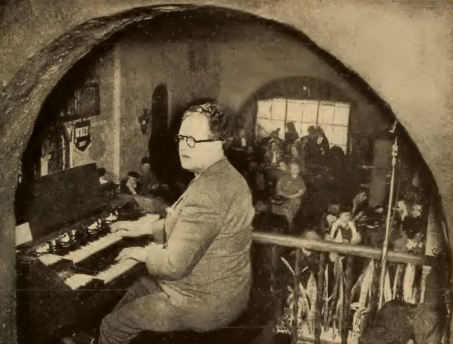 Photo of Nelson Selby playing an organ on the balcony of Laube's Old Spain restaurant in Buffalo, New York, in the 1940s